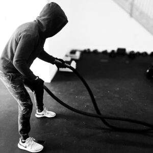 battle_ropes_bw Boxer performing conditioning training with battle ropes.