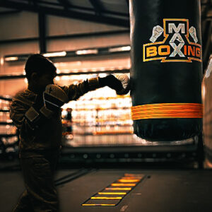 Image 1 Kid punching the heavy bag boxing at Max Boxing Gym